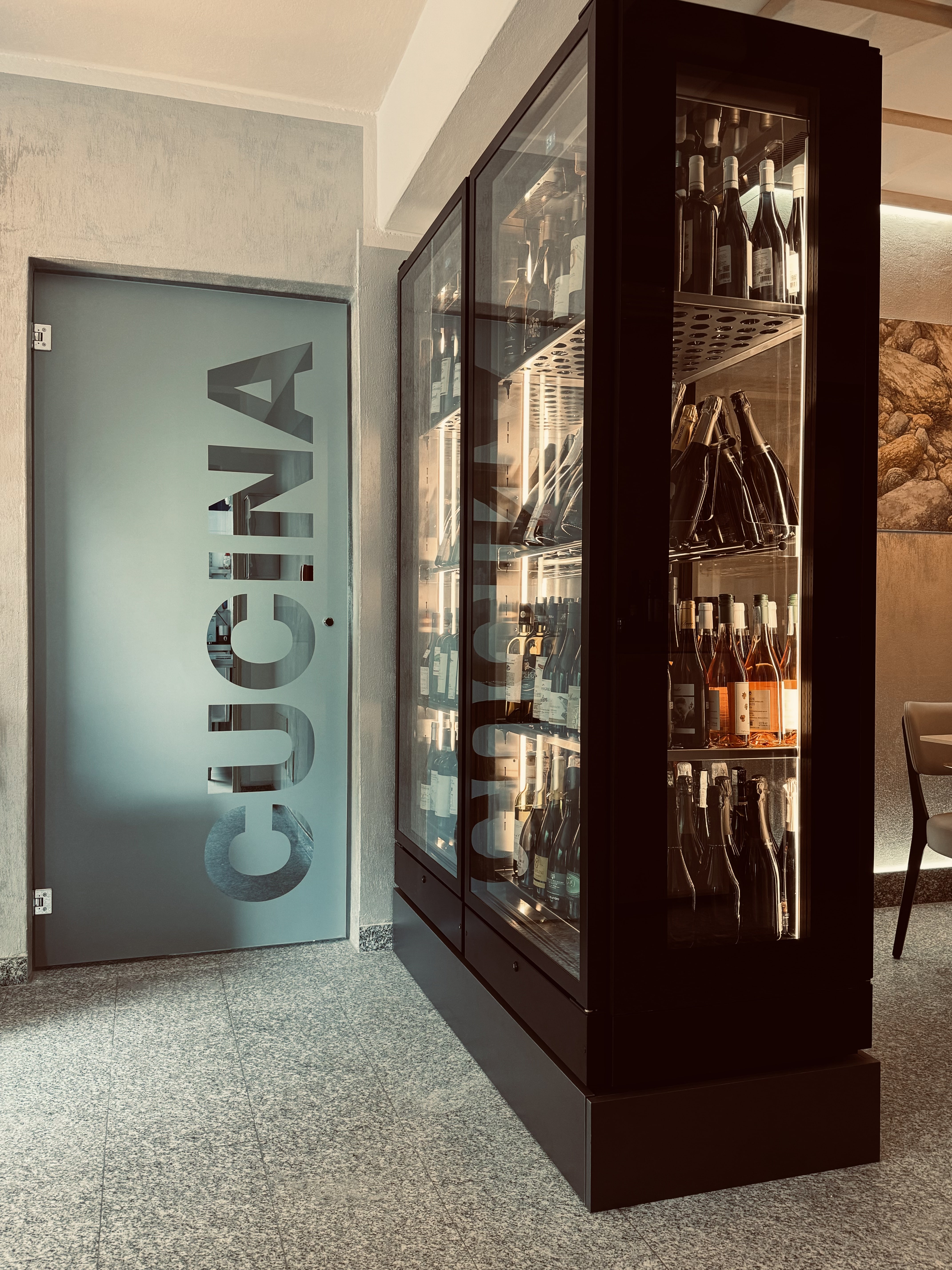 Kitchen door integrated into the wine cellar